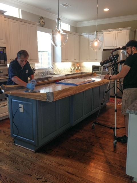 A picture of the making of our YouTube video. The crew is actually polishing the marble island in my kitchen.